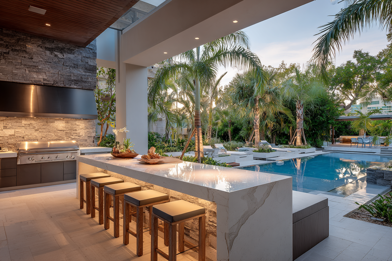 Luxury Fort Lauderdale outdoor kitchen with white quartz countertops and built-in grill, perfect for coastal living.