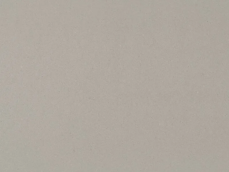 Caesarstone Clearskies quartz swatch: soft concrete gray surface with tiny specks