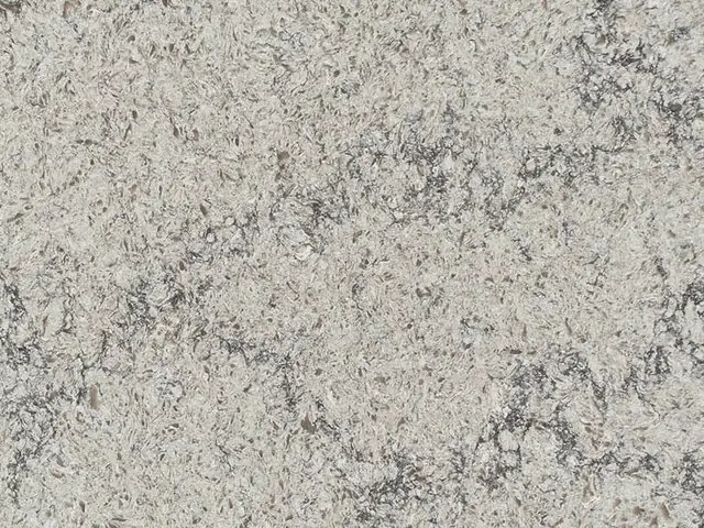 Caesarstone Himalayan Moon quartz swatch: white and gray aggregate background with dark veins