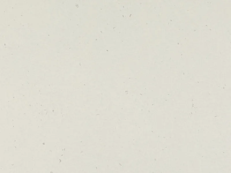 Caesarstone Misty Carrera quartz swatch: soft white background with light and dark gray splotches
