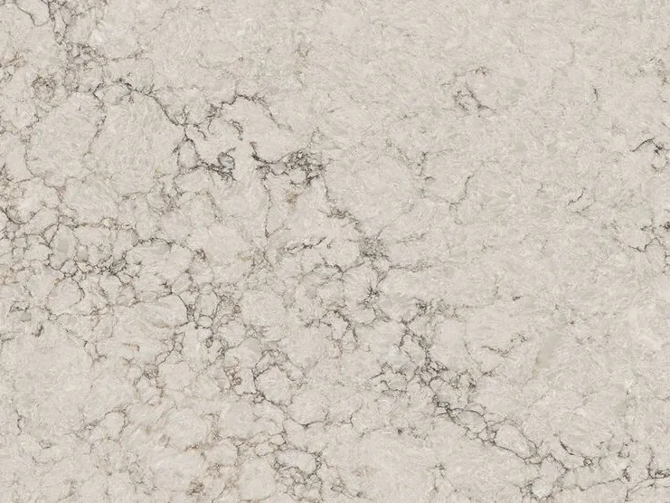 Caesarstone Moorland Fog quartz swatch: light taupe background with foggy brown and gray veins