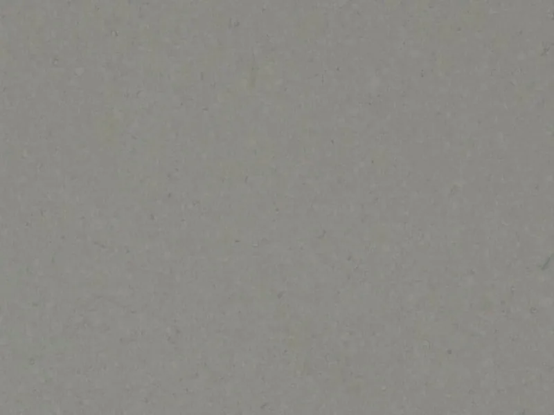 Caesarstone Pebble quartz swatch: ashen gray background with darker quartz chips