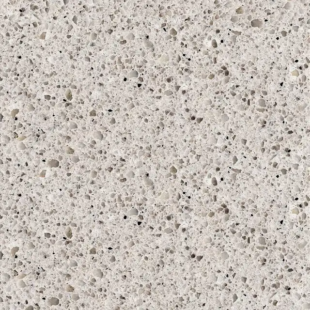 HanStone Quartz Rocky Shores swatch: cream background speckled with grey and umber chips