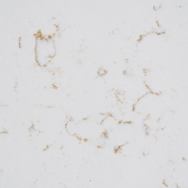 HanStone Quartz Whistler Gold swatch: white background with scattered golden brown wisps