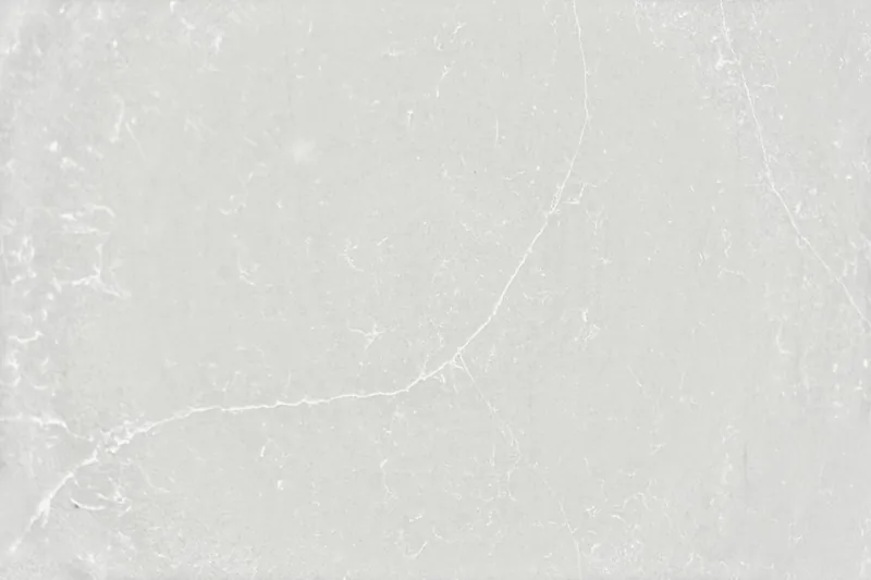 Silestone Desert Silver countertop swatch: light icy gray background with fine white veins