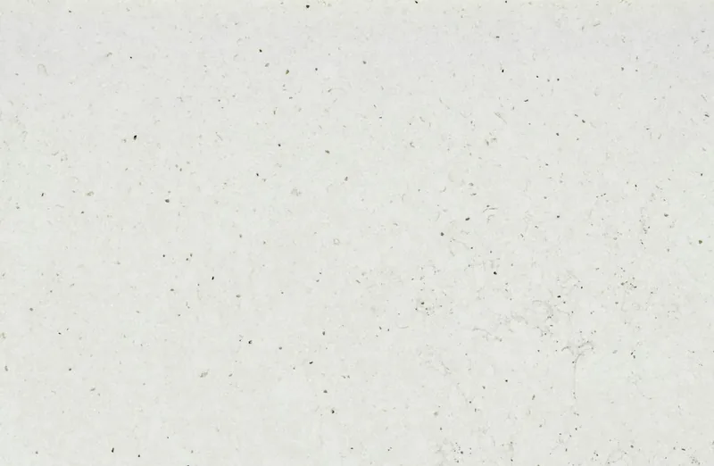 Silestone Lime Delight countertop swatch: pale warm limestone-look surface with tiny dark specks