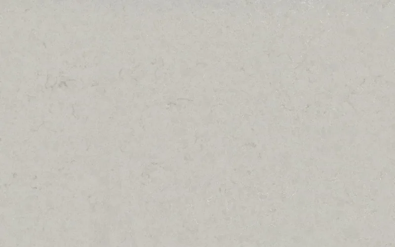 Silestone Motion Grey countertop swatch: warm gray limestone-look background with scattered veins