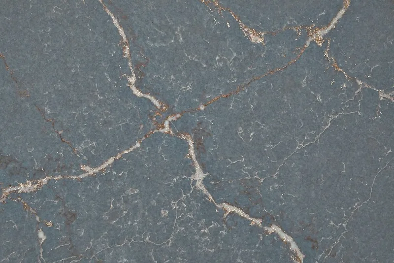 Silestone Parisien Bleu countertop swatch: deep blue background with white and ochre veins