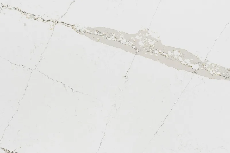 Silestone Toscana Cream countertop swatch: white background with a wide beige vein band
