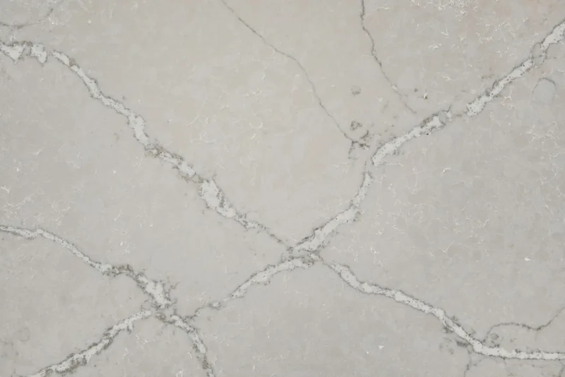 Silestone Victorian Silver countertop swatch: light gray background with crisscrossing silver and dark gray veins