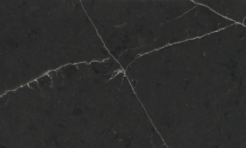 Wilsonart Enchanted Rock quartz swatch: black marble-look surface with moderate veining