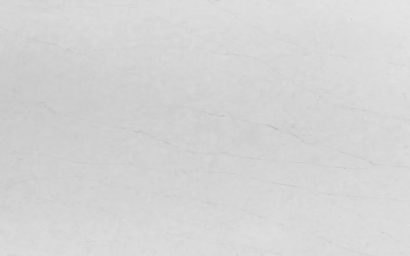 Wilsonart Marble Falls quartz swatch: white marble-look surface with subtle veining