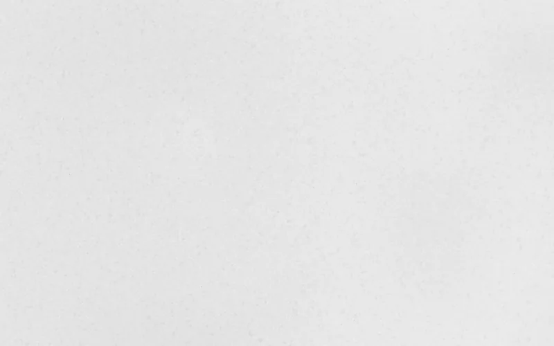 Wilsonart Niwa quartz swatch: white fine-speckled surface with no veining