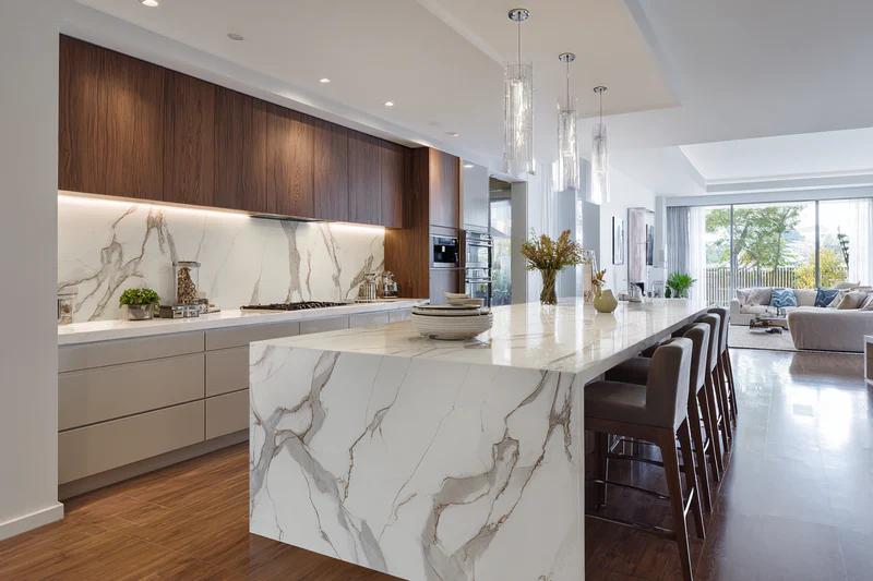 Kitchen with Calacatta quartz, walnut cabinets and leather stools