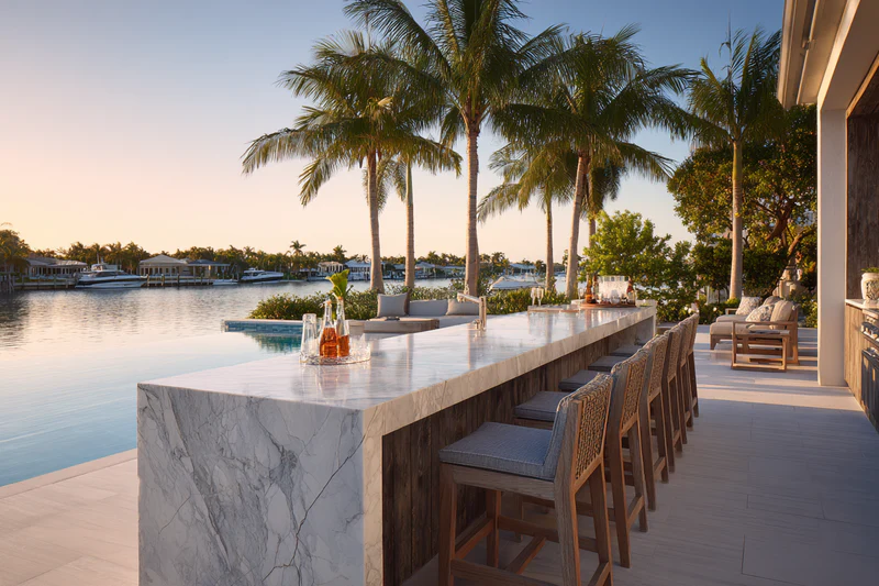 Outdoor bar with infinity pool at sunset
