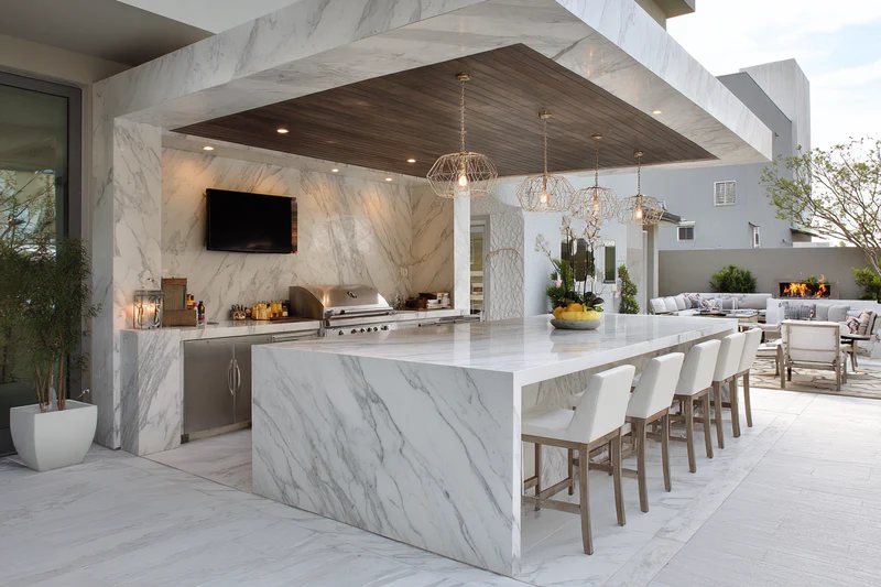 Outdoor kitchen with fireplace and wood ceiling